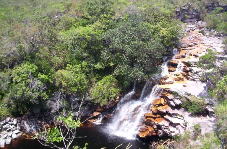 Rio Mucugezinho formando cachoeira entre rochas e mata, visto de cima